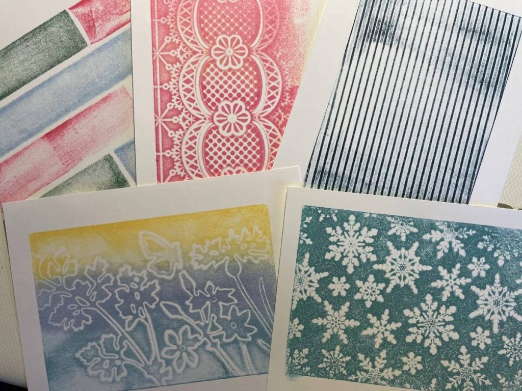 Inked card panels made using stamping foam on different surfaces.