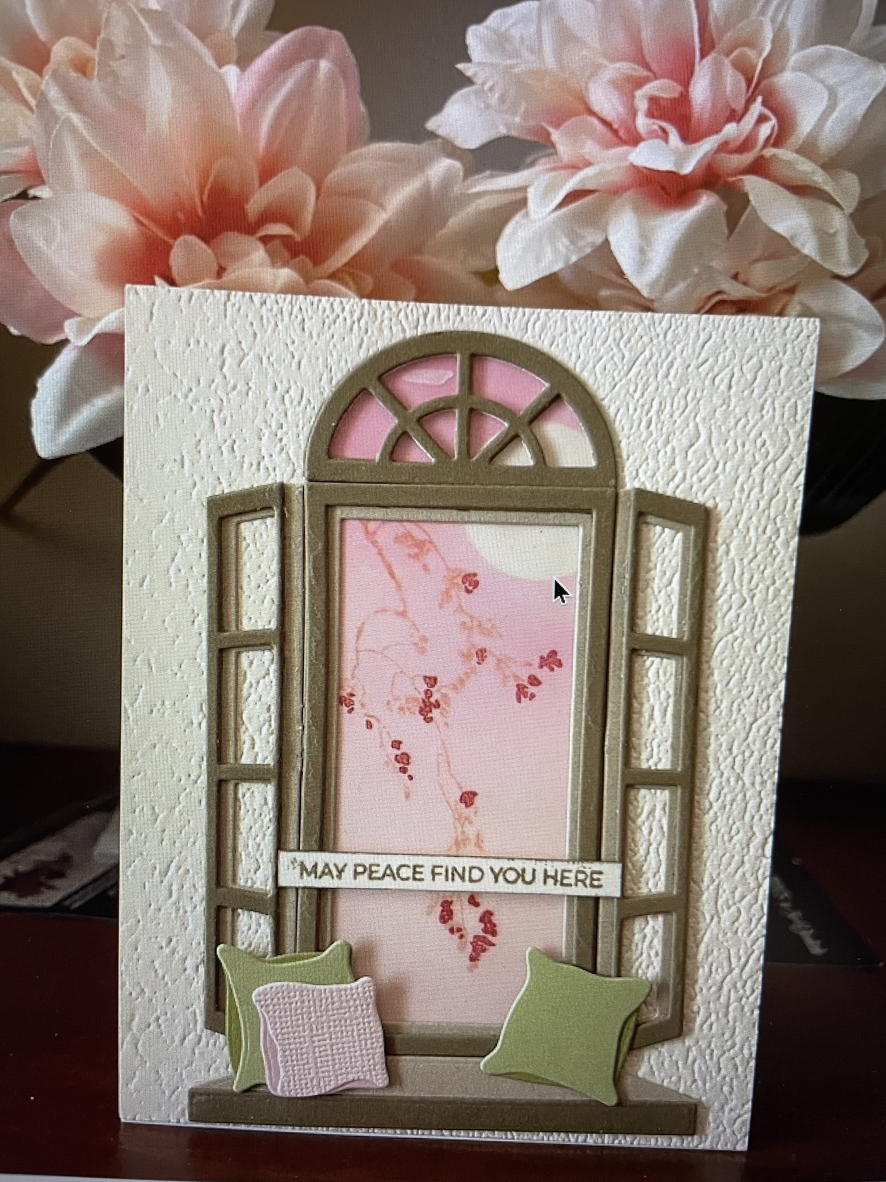 a card showing an open window with seat and pillows